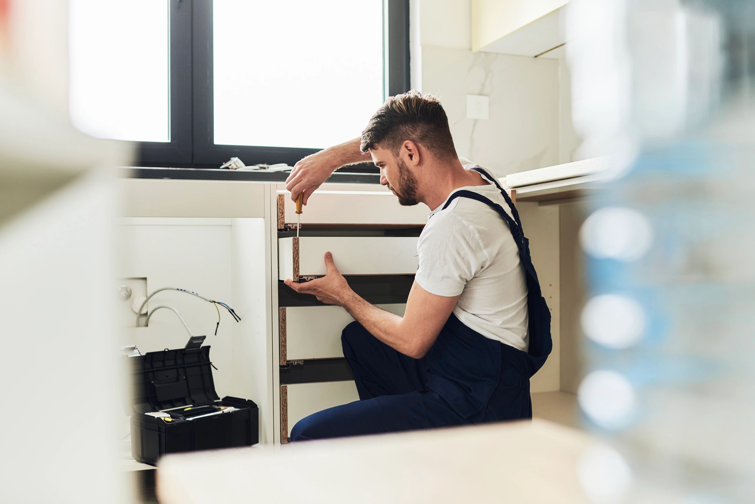 Young worker at construction site Tradesperson working on a home renovation repair task